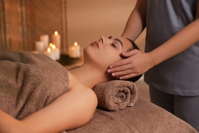 Photo of Young woman receiving massage in spa salon