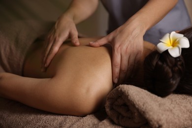 Woman receiving back massage in spa salon, closeup