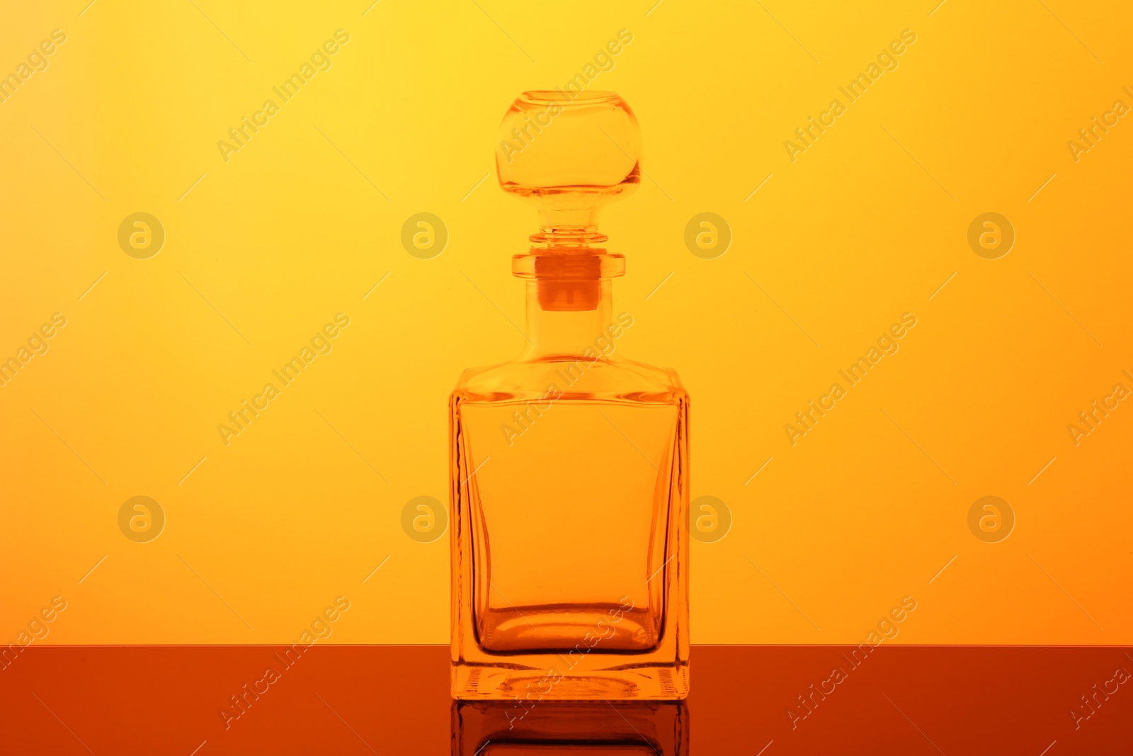 Photo of One empty glass bottle on table, color tone effect