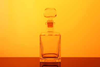 Photo of One empty glass bottle on table, color tone effect