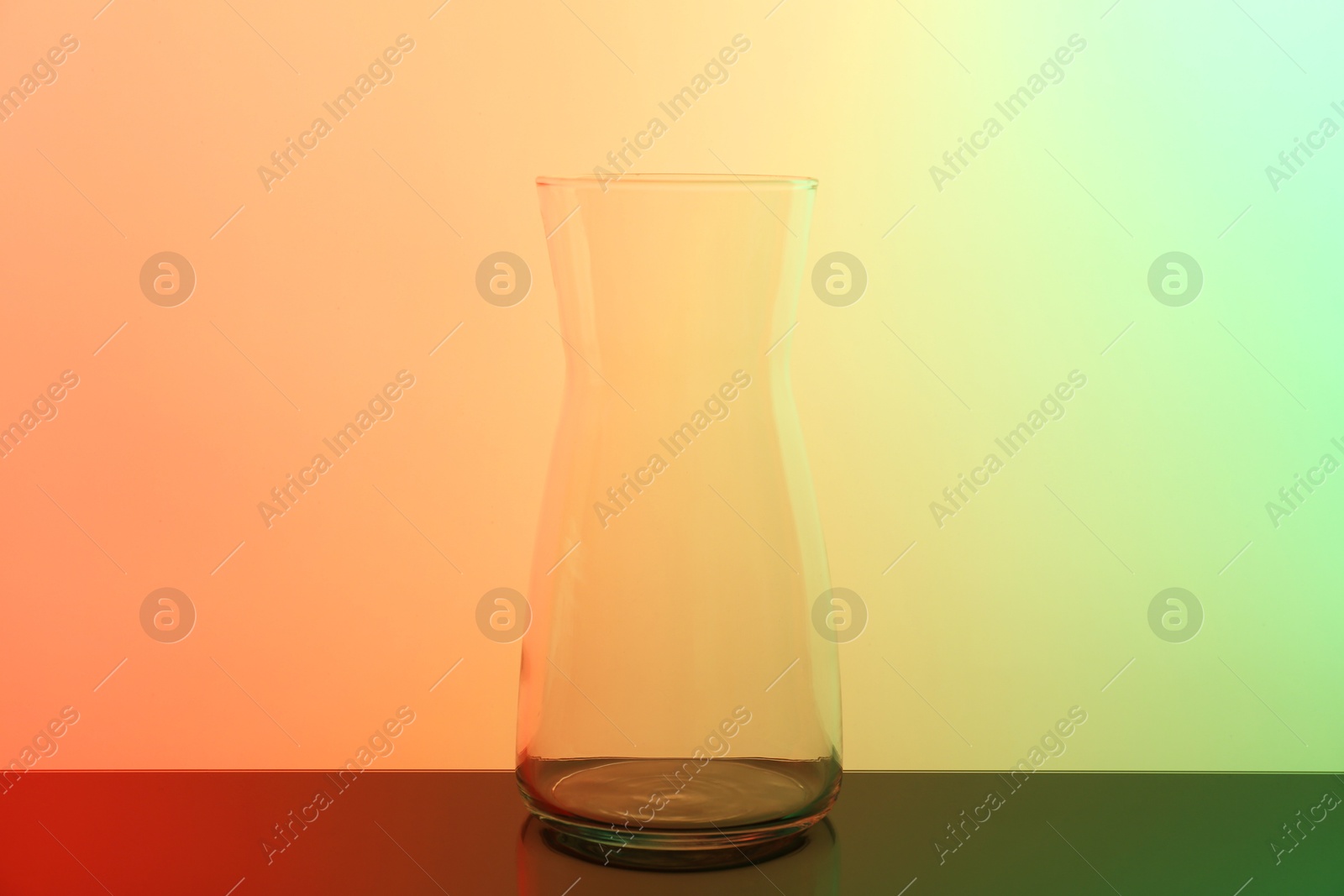 Photo of Empty glass jug on table, color tone effect