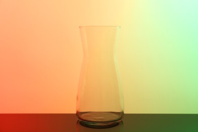 Photo of Empty glass jug on table, color tone effect