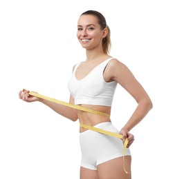 Weight loss. Happy woman measuring her slim waist with tape on white background