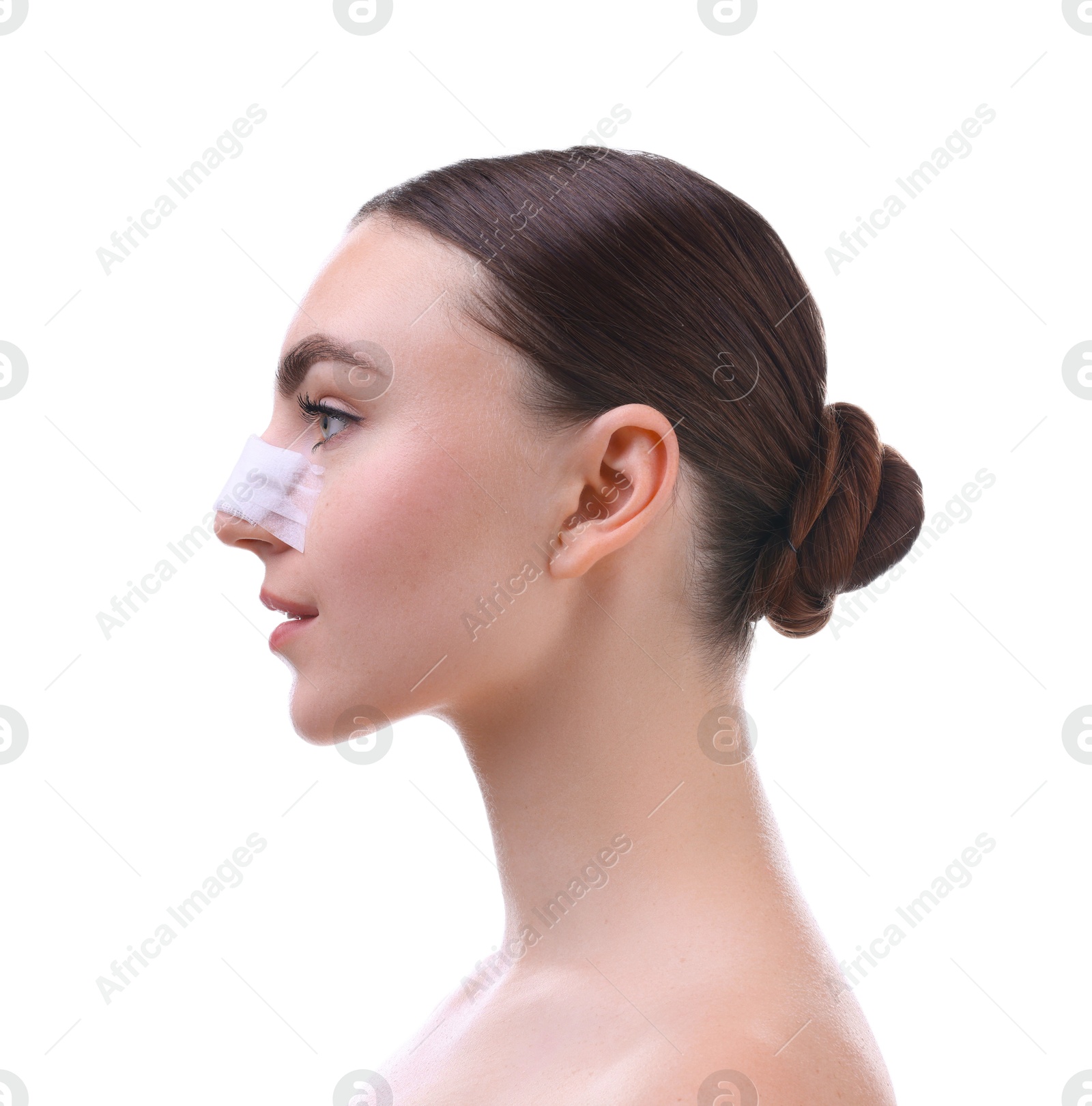 Photo of Woman with medical bandage on her nose after plastic surgery operation against white background