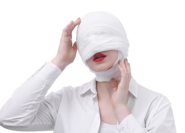 Photo of Woman with face wrapped in medical bandage after plastic surgery operation on white background