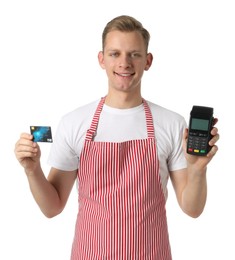 Photo of Happy young man in apron with payment terminal and debit card on white background