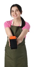 Happy young woman in apron with payment terminal on white background