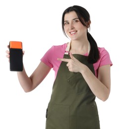 Happy young woman in apron with payment terminal on white background