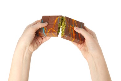 Photo of Woman breaking Dubai chocolate bar on white background, closeup