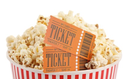 Photo of Tasty popcorn and movie tickets isolated on white