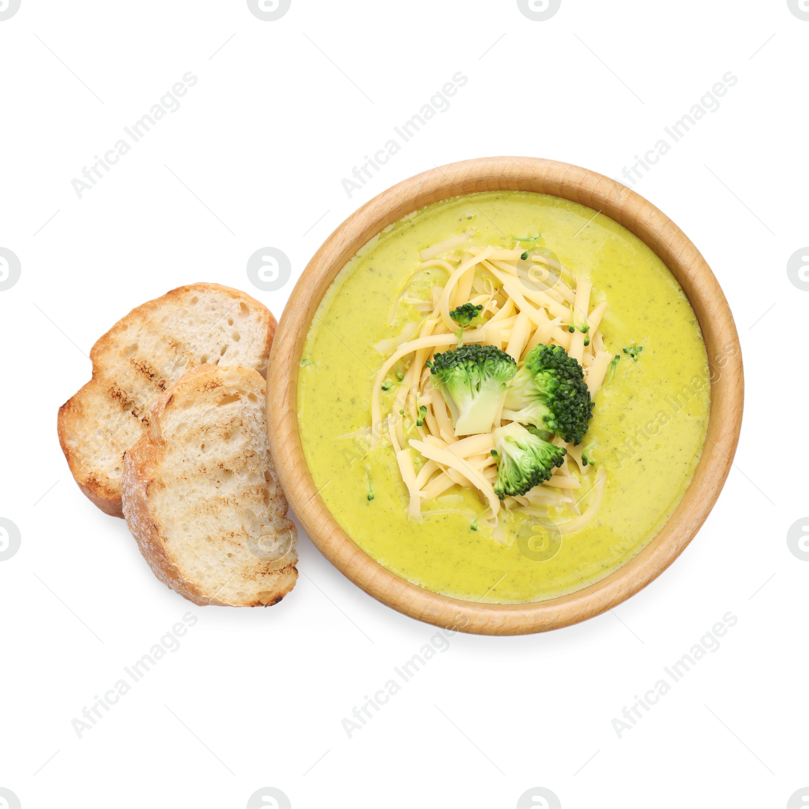 Photo of Delicious broccoli cream soup in bowl and croutons isolated on white, top view