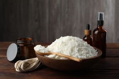 Photo of Soy wax and other supplies for making candles on wooden table