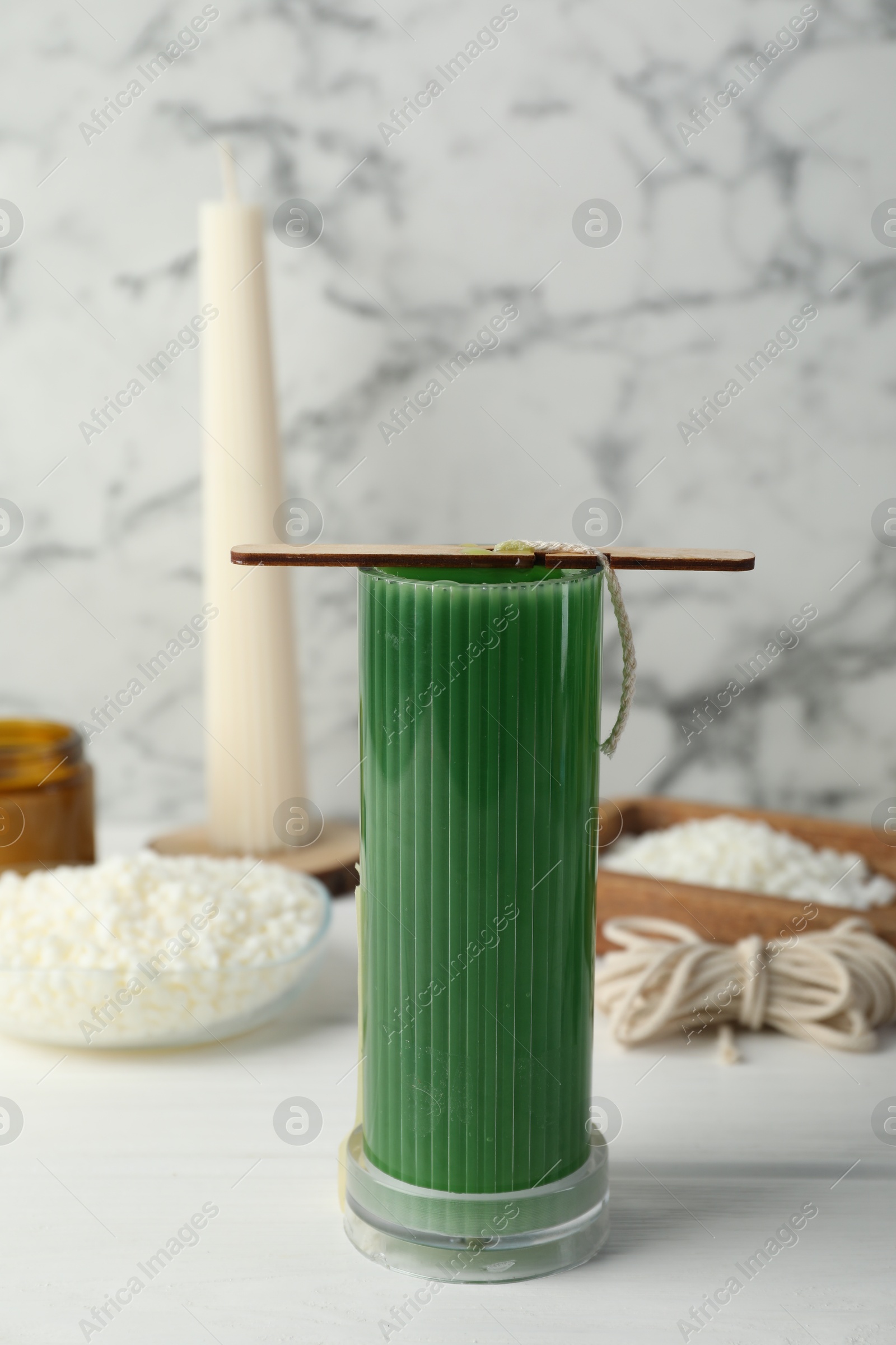 Photo of Soy wax candle with stabilizer on white wooden table