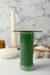 Photo of Soy wax candle with stabilizer on white wooden table