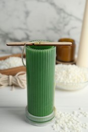 Photo of Soy wax candle with stabilizer on white wooden table