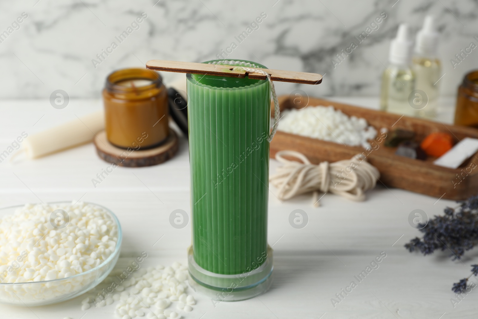 Photo of Soy wax candle with stabilizer on white wooden table