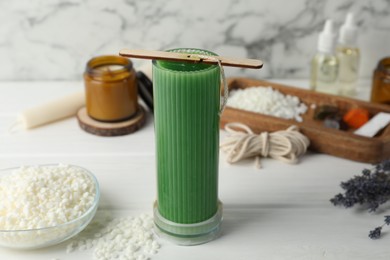 Photo of Soy wax candle with stabilizer on white wooden table