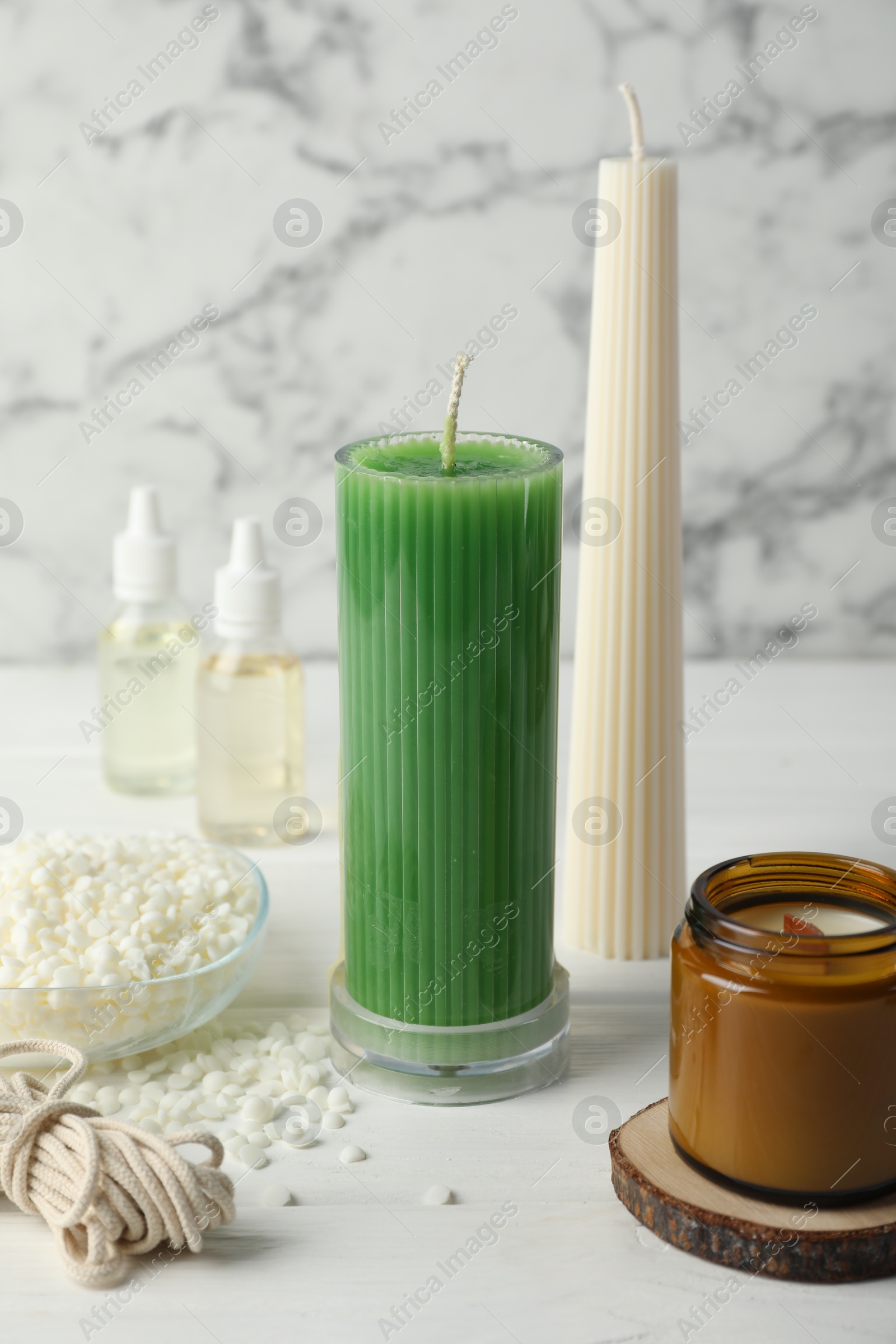 Photo of Soy wax candles on white wooden table