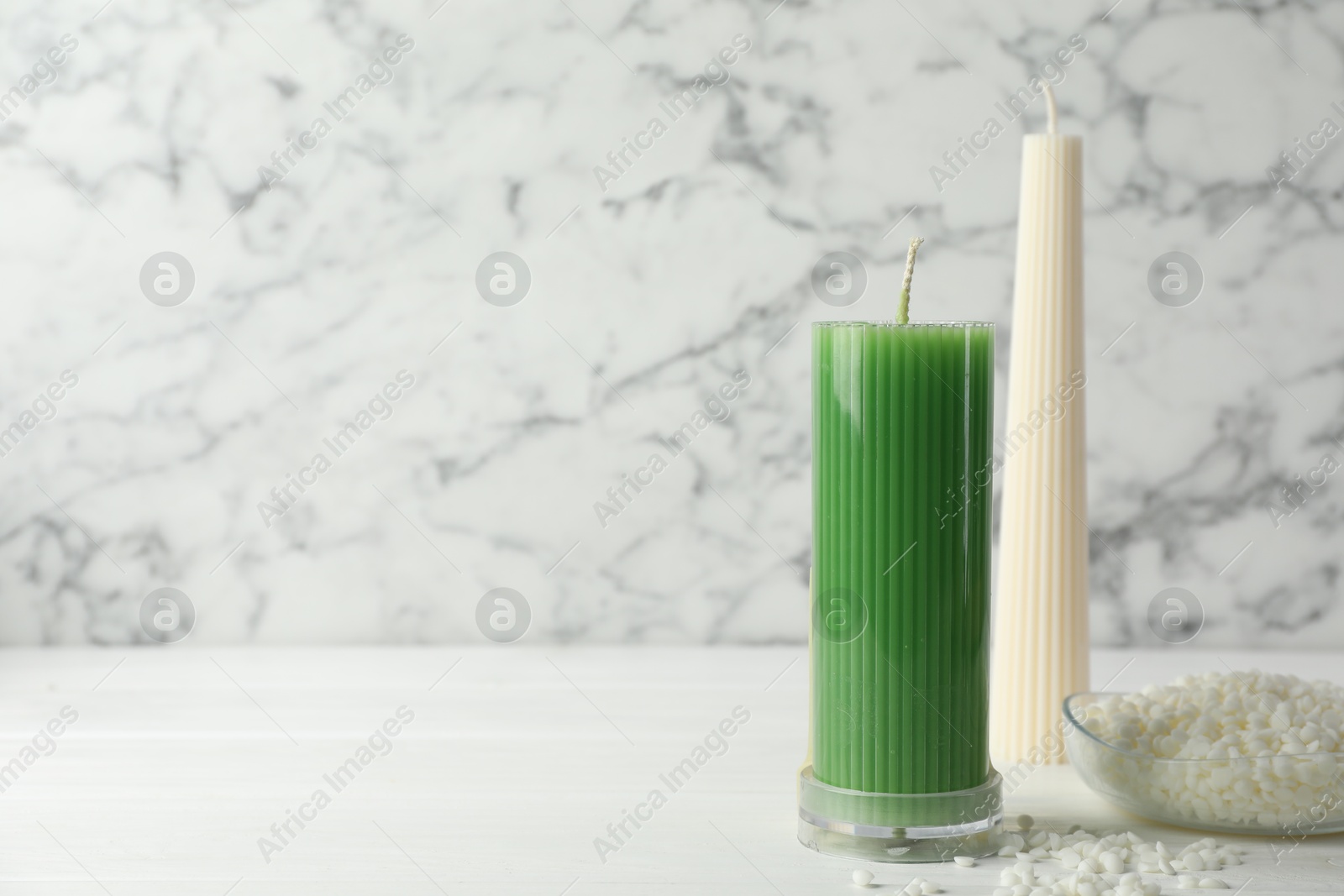 Photo of Soy wax candles on white wooden table, space for text