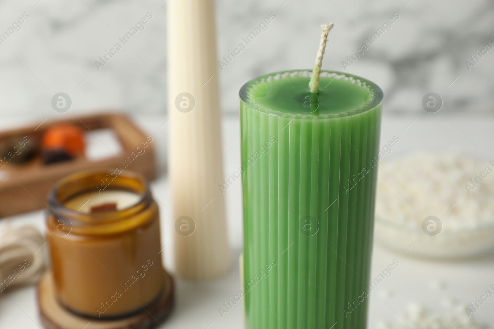 Photo of Soy wax candles on light table, closeup