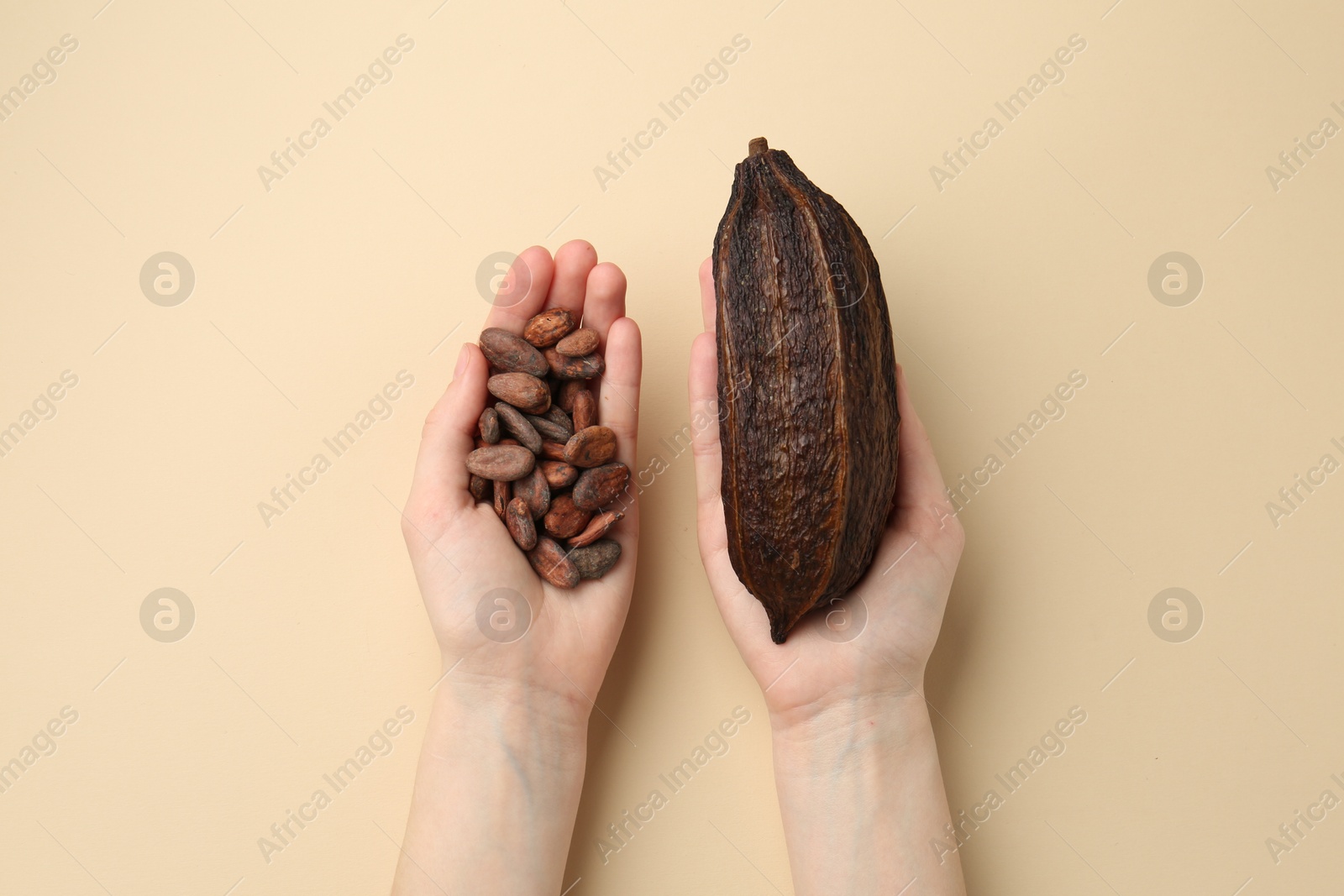 Photo of Woman with cocoa pod and beans on beige background, top view