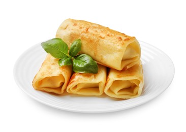 Photo of Delicious rolled crepes with basil isolated on white