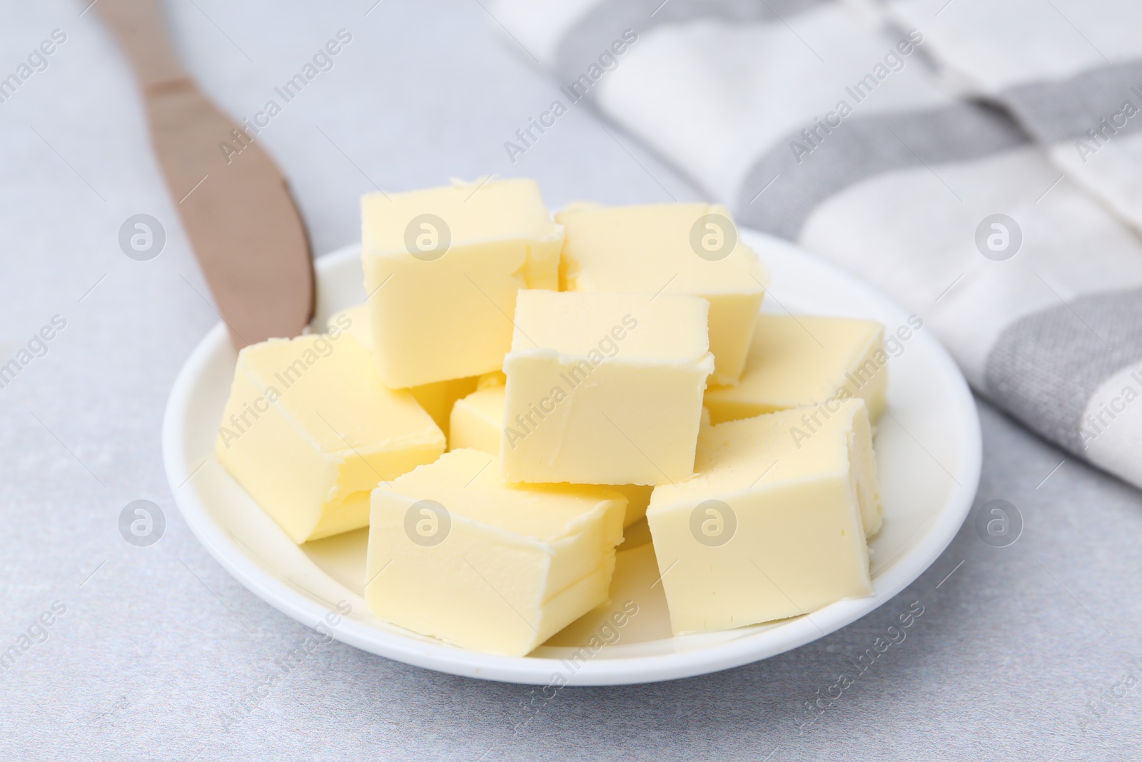 Photo of Pieces of fresh butter on white table, closeup