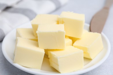 Pieces of fresh butter on white table, closeup