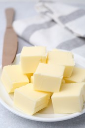 Photo of Pieces of fresh butter on white table, closeup