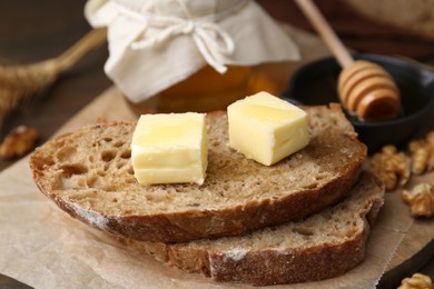 Photo of Slices of bread with butter and honey on table, closeup