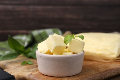 Pieces of butter on wooden board, closeup