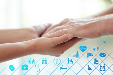 Image of Caregiver and elderly man against blurred background, closeup of hands. Healthcare icons