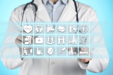 Image of Doctor using virtual screen with healthcare icons on light blue background, closeup