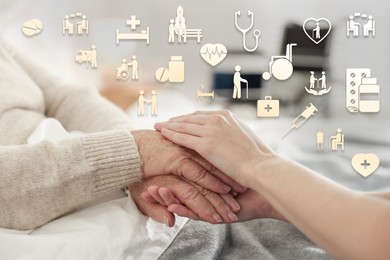 Image of Caregiver and elderly woman against blurred background, closeup of hands. Healthcare icons