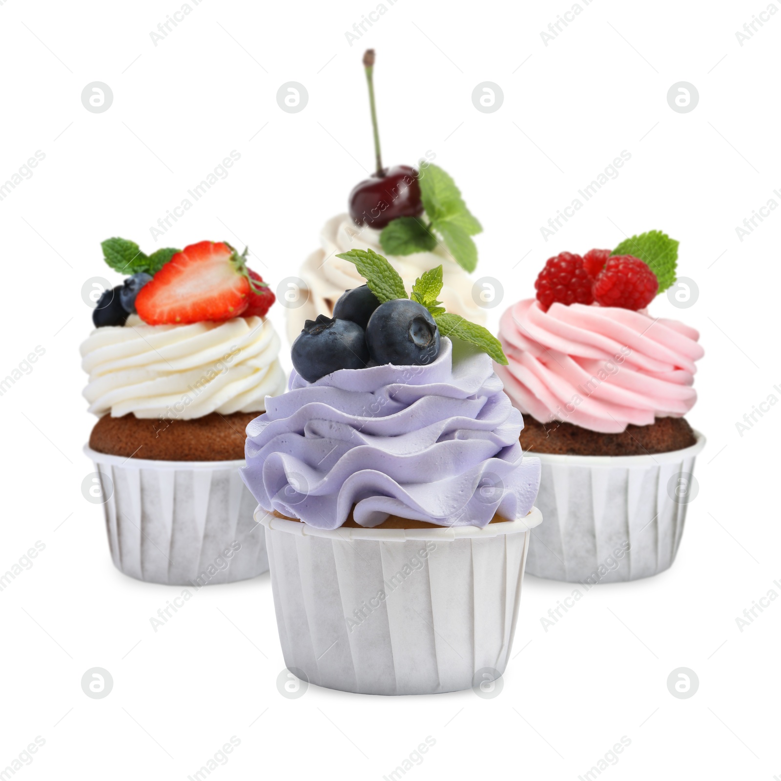 Image of Delicious cupcakes with berries isolated on white