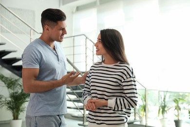 Man and woman having conversation in hall