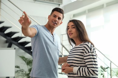 Man and woman having conversation in hall