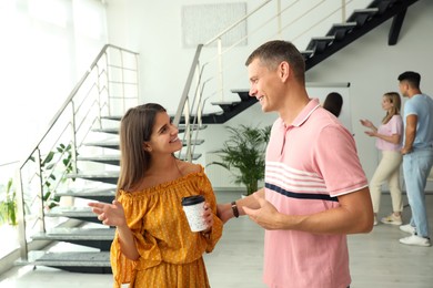 Photo of Man and woman having conversation in hall