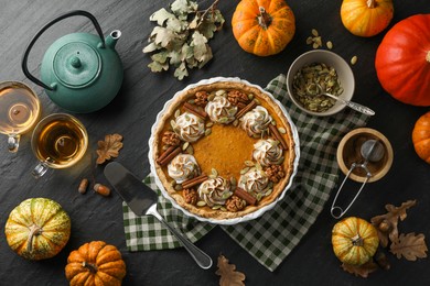 Photo of Flat lay composition with homemade pumpkin pie on black table