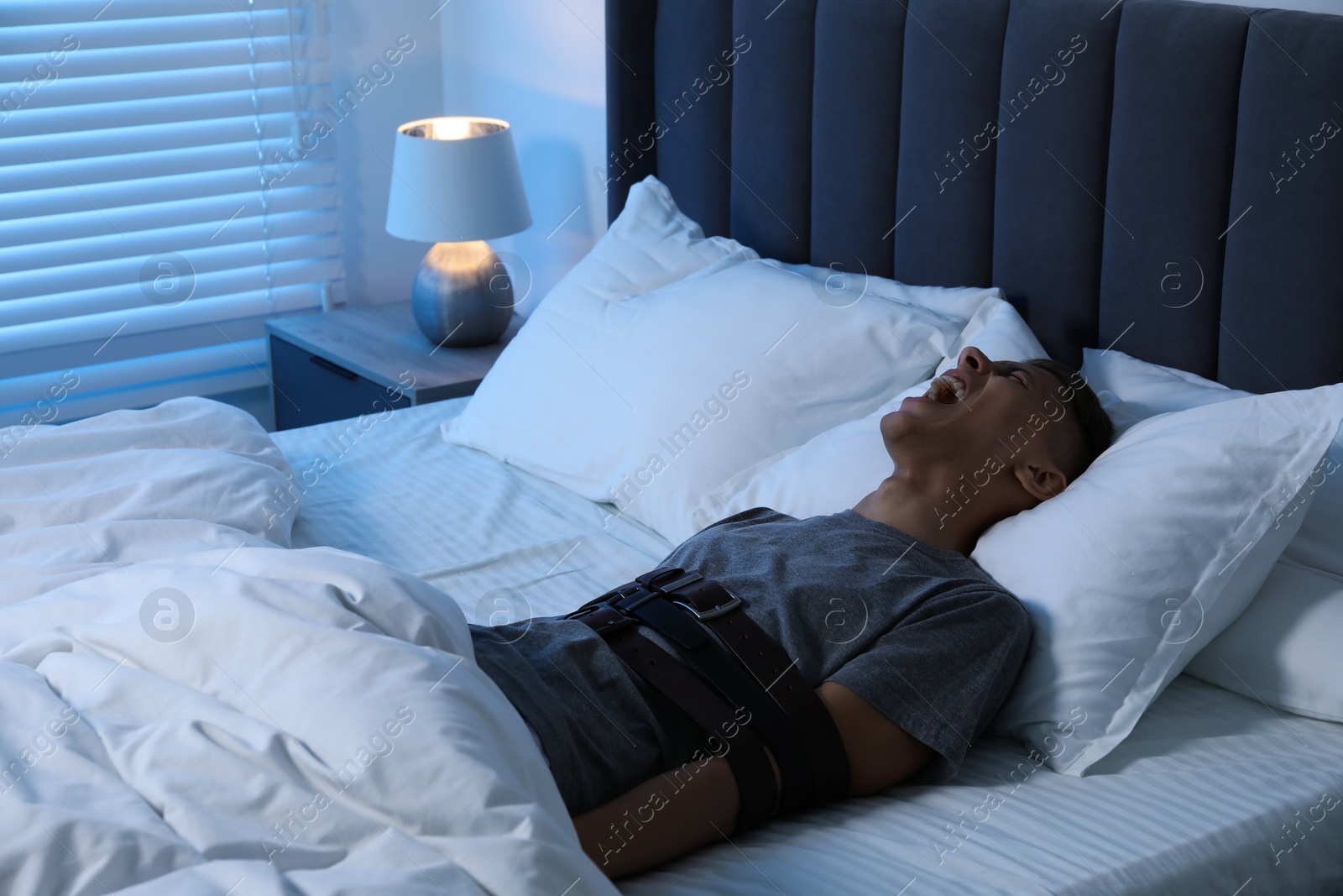 Photo of Man in sleepwalking condition screaming in bed