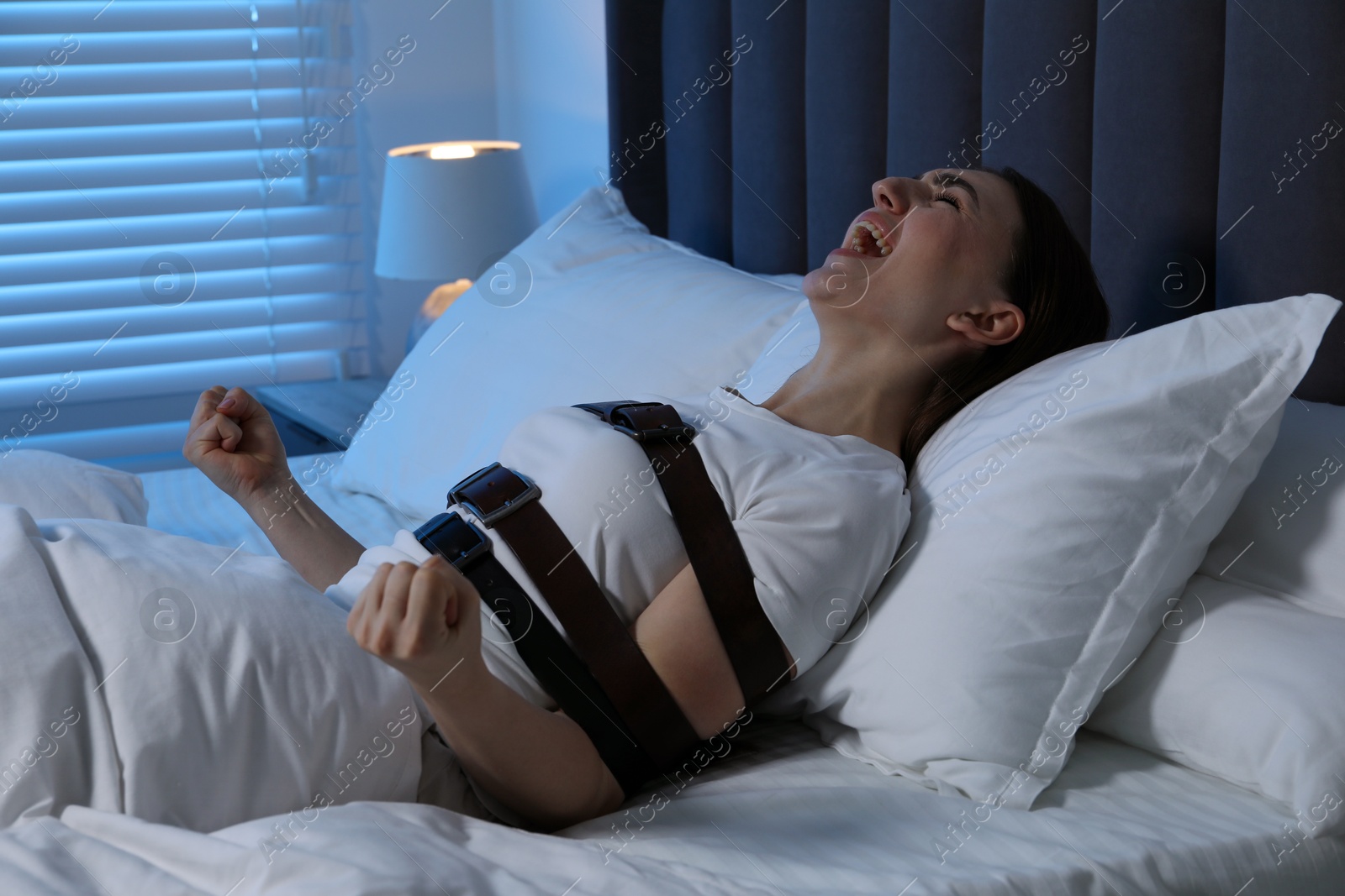 Photo of Woman in sleepwalking condition screaming in bed