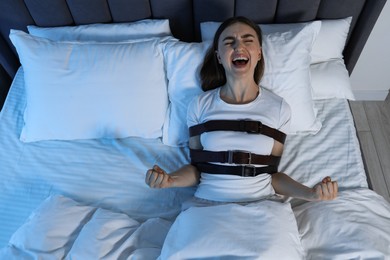 Photo of Woman in sleepwalking condition screaming in bed, above view