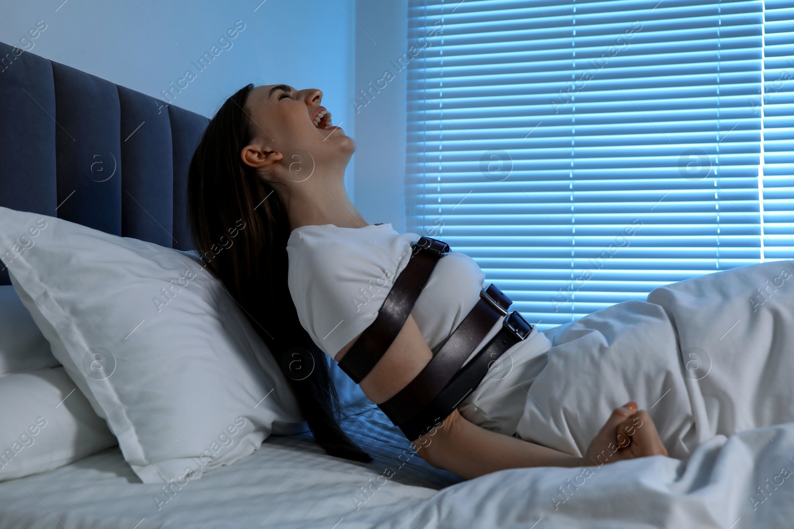 Photo of Woman in sleepwalking condition screaming in bed