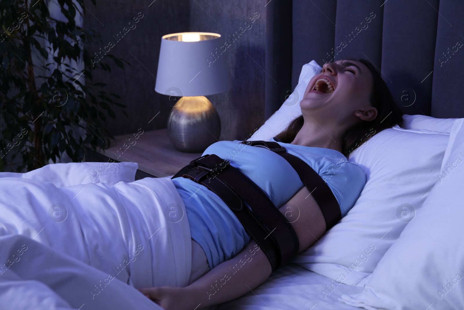 Photo of Woman in sleepwalking condition screaming in bed