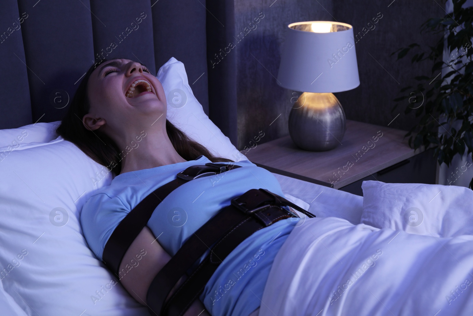 Photo of Woman in sleepwalking condition screaming in bed