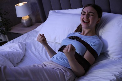 Photo of Woman in sleepwalking condition screaming on bed