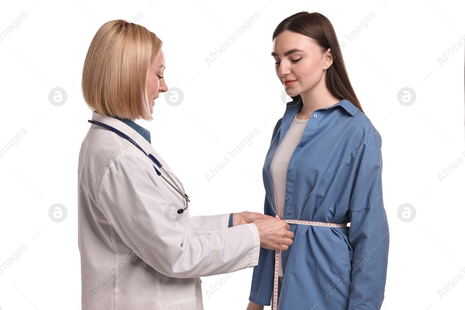 Photo of Weight loss. Nutritionist measuring patient's waist with tape on white background