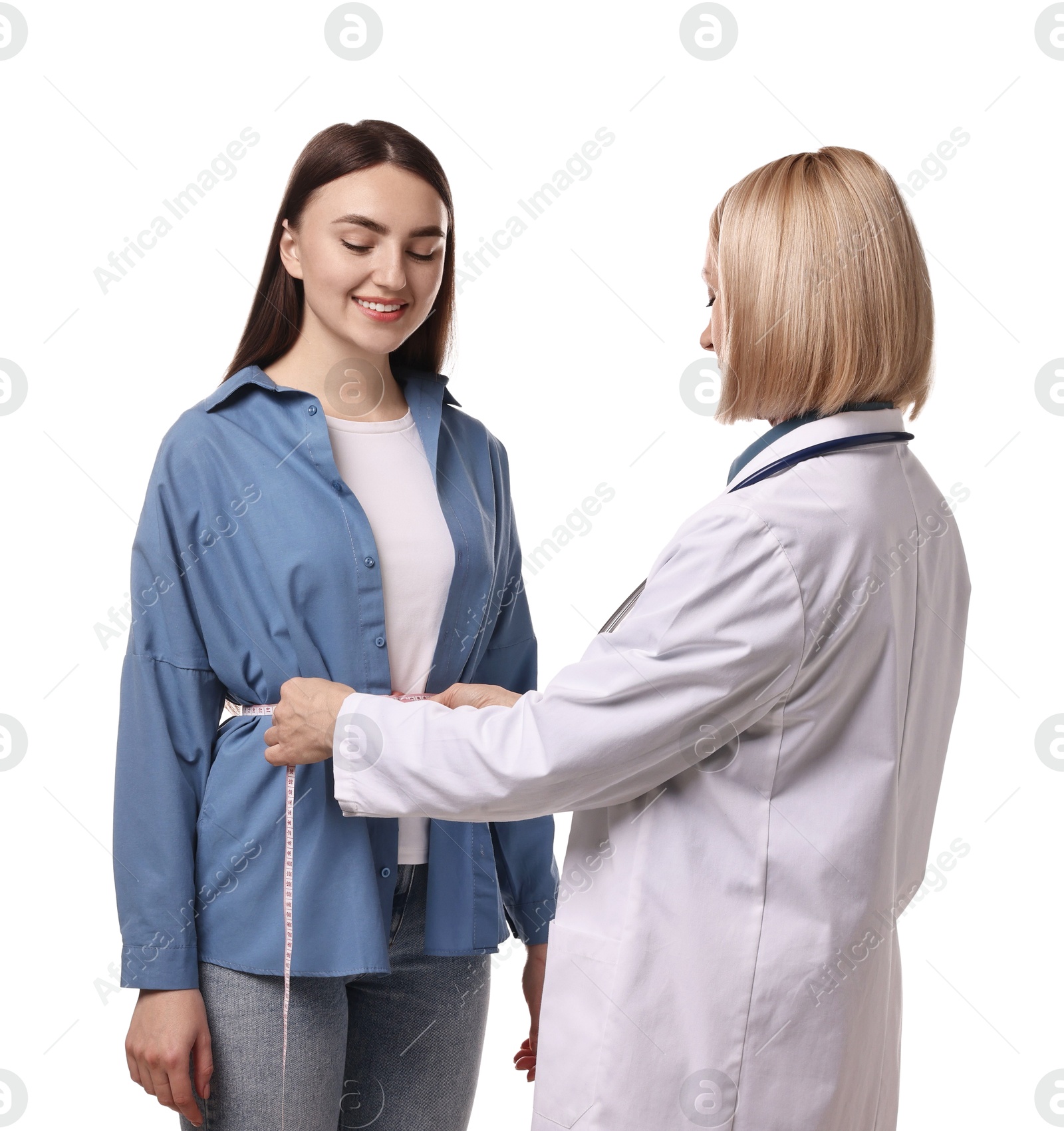 Photo of Weight loss. Nutritionist measuring patient's waist with tape on white background