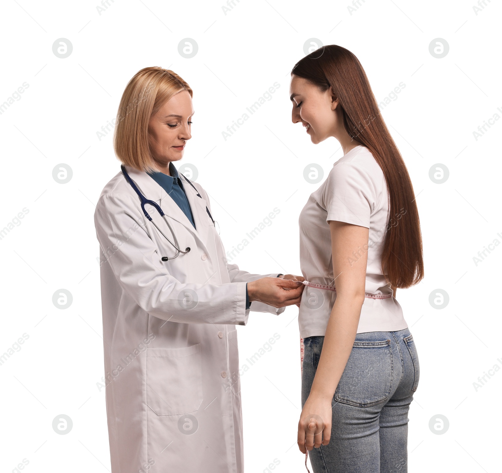 Photo of Weight loss. Nutritionist measuring patient's waist with tape on white background