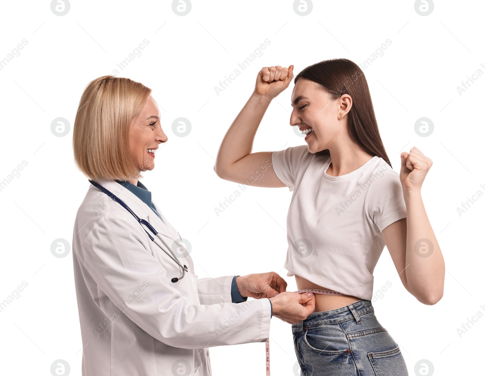 Photo of Happy woman lost weight. Nutritionist measuring patient's waist with tape on white background